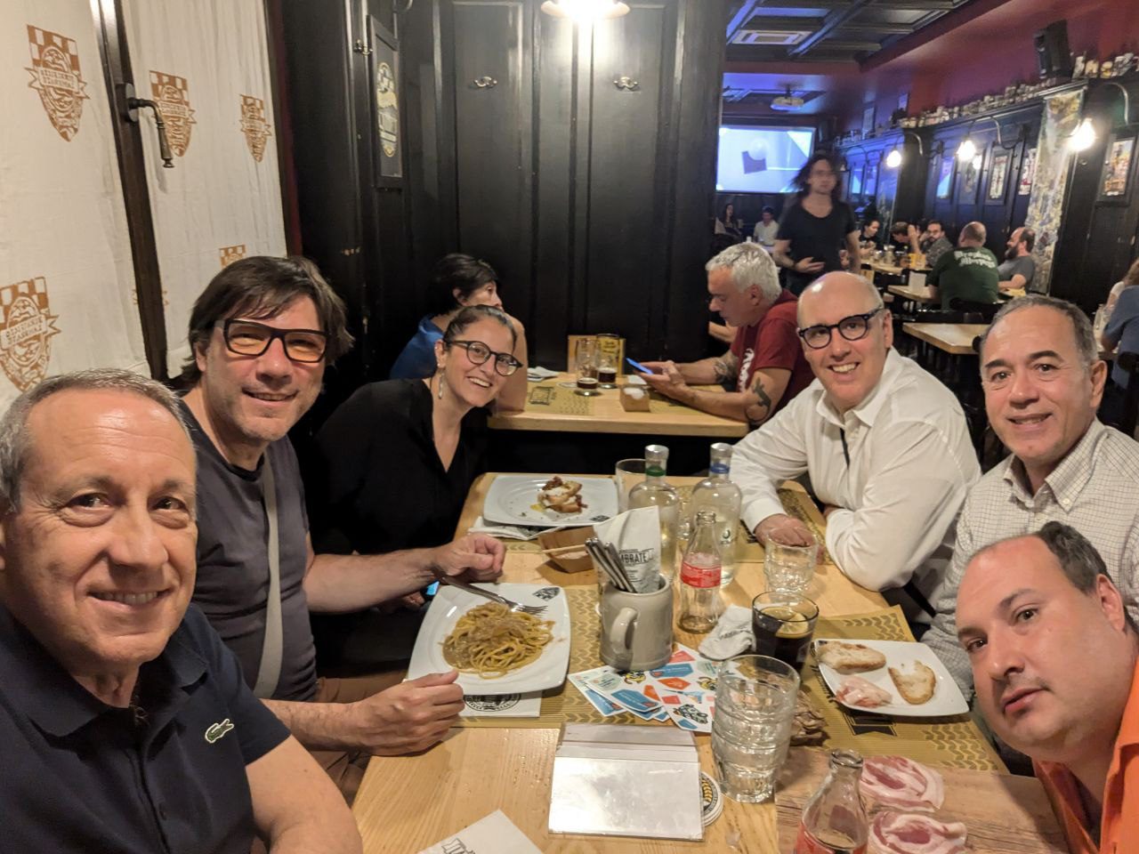 group of people sitting at the table eating