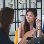 two women engaging in respectful conversation while listening attentively